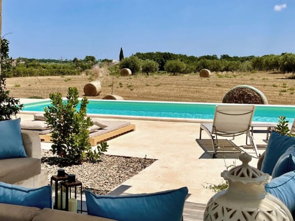 Wide-open views over the surrounding wheat fields and olive groves.